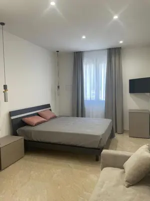a bedroom with a large bed and a couch at Olea in Castelluzzo
