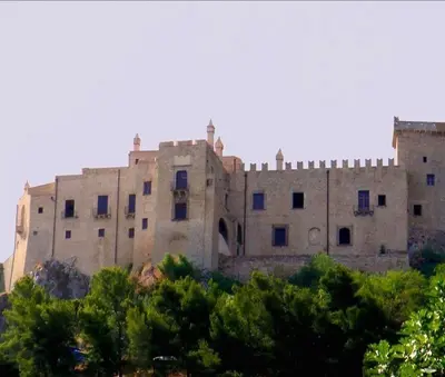 a large stone building with trees in front of it at Onda blu in Carini