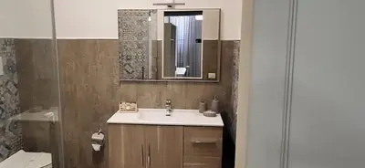 a bathroom with a sink and a mirror at De Luca in Palermo