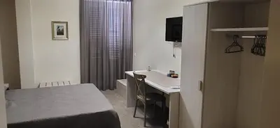 a hotel room with a bed and a sink at De Luca in Palermo