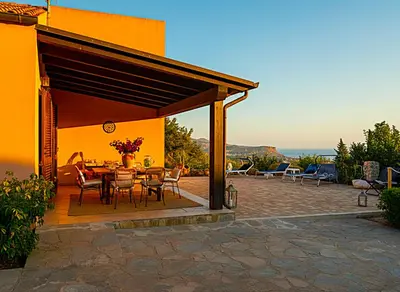 two people sitting in a hot tub with a view at Villasara Scopello relax con 4 camere piscina&SPA in Castellammare del Golfo