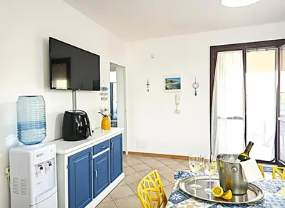 a hotel room with three beds and a dresser at Villasara Scopello relax con 4 camere piscina&SPA in Castellammare del Golfo
