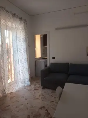 a living room with a couch and a window at La casa sulla piazza in Cerda