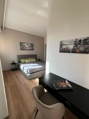 a bedroom with a bed and a desk with a chair at LaPignaVerde in Palermo