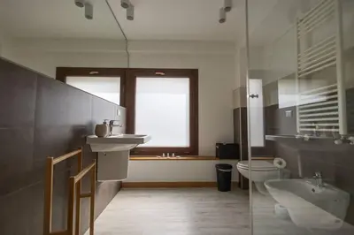 a bathroom with a sink and a toilet and a window at iFlat Corte Seralcadi in Palermo