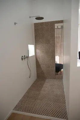 a bathroom with a shower with brown tile at Casa Degli Aragonesi in Palermo