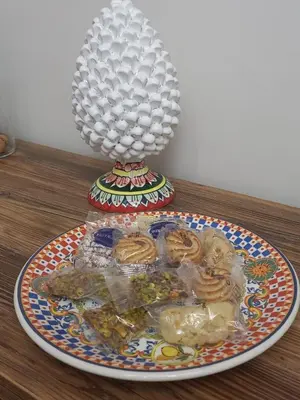 a plate of food on a table with a lamp at Residenza del Massimo in Palermo