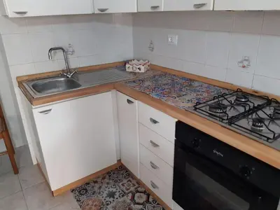 a kitchen with a sink and a stove at Nonna Giovanna in Castellammare del Golfo