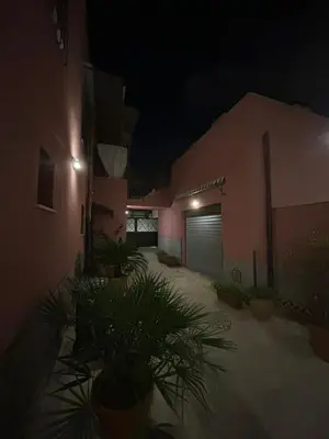 a building with a garage at night at Casa Patry in Palermo