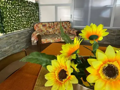 a table with yellow sunflowers on top of it at Casa Patry in Palermo