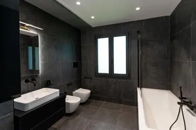 a bathroom with a sink and a tub and a toilet at Villa Tina Mondello in Mondello