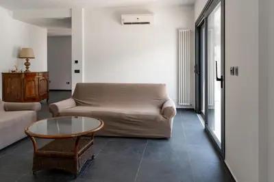 a living room with a couch and a glass table at Villa Tina Mondello in Mondello