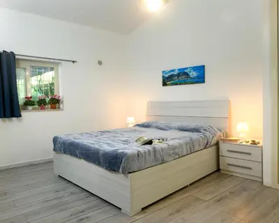 a bedroom with a bed and two night stands at Villa Rosa Mondello in Mondello
