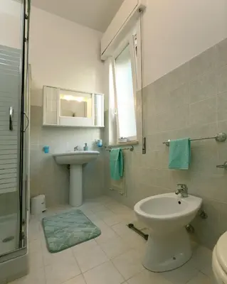 a bathroom with a toilet and a sink at Villa Rosa Mondello in Mondello