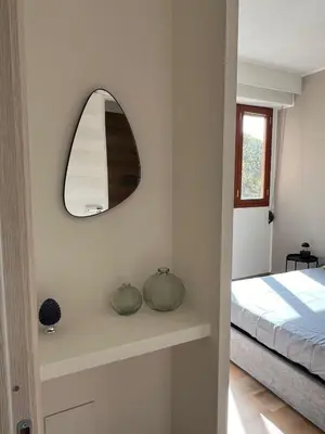 a bedroom with a mirror and a bed at LaPignaVerde Suites in Palermo