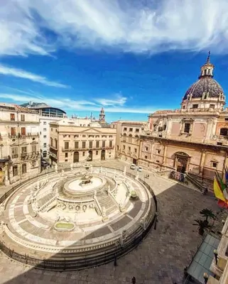 a large building with a fountain in front of it at 145 Maqueda Palermo in Palermo
