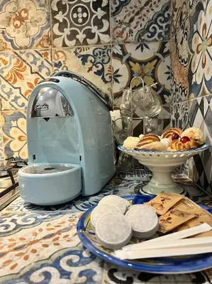 a table topped with a plate of pastries and a bread maker at Casa Vacanze Tirreno in Trabia