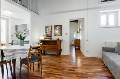 a living room with a table and a couch at GuestHost - Vucciria & La Cala Lovely Apartment with Terrace in Palermo