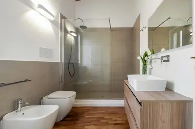 a bathroom with a toilet and a sink and a shower at GuestHost - Vucciria & La Cala Lovely Apartment with Terrace in Palermo