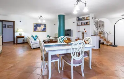 a dining room and living room with a table and chairs at Cozy Home In Partinico in Partinico