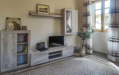 a living room with a television on a wooden entertainment center at Amazing Home In Castellammare Del Golf in Castellammare del Golfo