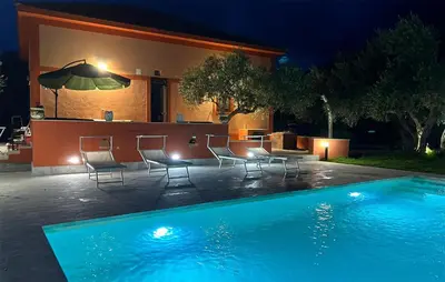 a swimming pool in front of a house at night at Amazing Home In Castellammare Del Golf in Castellammare del Golfo