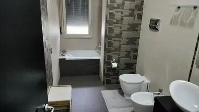 a bathroom with a toilet and a tub and a sink at Casa Stella in Palermo