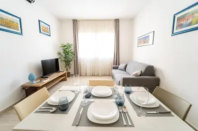 a living room with a dining table and a couch at Central Station Apartment 24 in Palermo