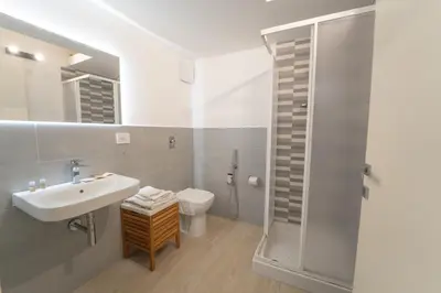 a bathroom with a sink and a toilet and a shower at Central Station Apartment 24 in Palermo