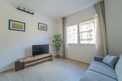 a living room with a couch and a television at Central Station Apartment 24 in Palermo