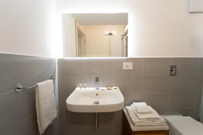 a bathroom with a sink and a mirror at Central Station Apartment 24 in Palermo