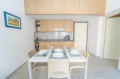 a white dining room with a white table and chairs at Central Station Apartment 24 in Palermo