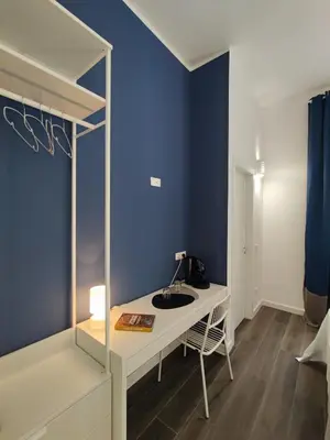 a bathroom with a sink and a blue wall at Donna Oliva Guest House in Palermo