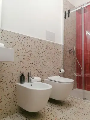 a bathroom with a toilet and a sink at Donna Oliva Guest House in Palermo
