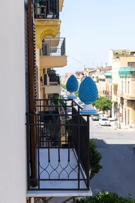 a balcony with blue spheres on the side of a building at La Dimora dei Paladini in Bagheria