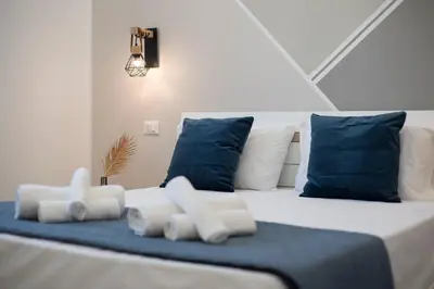 a large bed with blue and white pillows at Bed and Breakfast Da Francesca in Castelluzzo