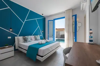 a blue bedroom with a bed and a blue wall at Bed and Breakfast Da Francesca in Castelluzzo