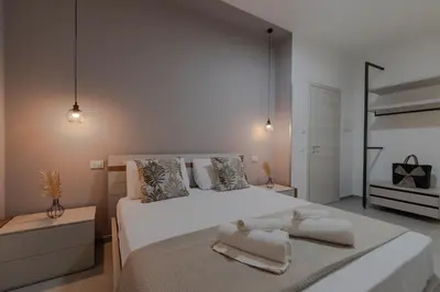 a bedroom with a large white bed with two towels on it at Bed and Breakfast Da Francesca in Castelluzzo