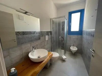 a bathroom with a sink and a toilet and a shower at Bed and Breakfast Da Francesca in Castelluzzo