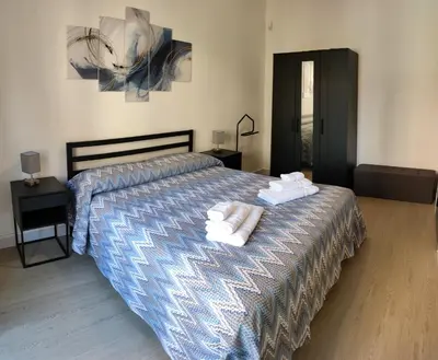 a bedroom with a bed with towels on it at Casa Magarìa in Palermo