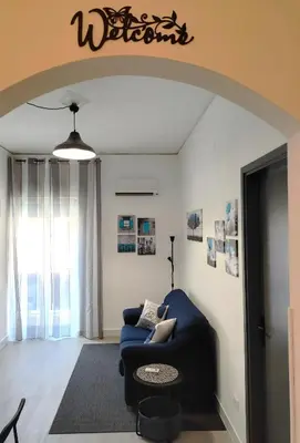 a living room with a blue couch in a room at Casa Magarìa in Palermo