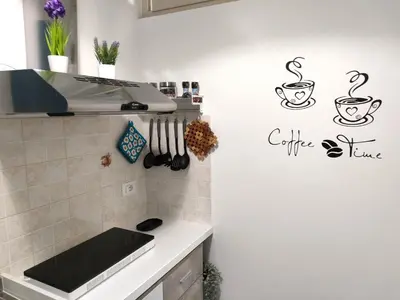 a kitchen with a counter with a coffee sign on the wall at Casa Magarìa in Palermo