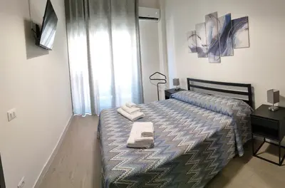 a bedroom with a bed with two towels on it at Casa Magarìa in Palermo