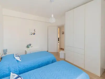 a bedroom with two blue beds and white cabinets at Casa Vacanze La Dolce Vita in Mandra Capreria
