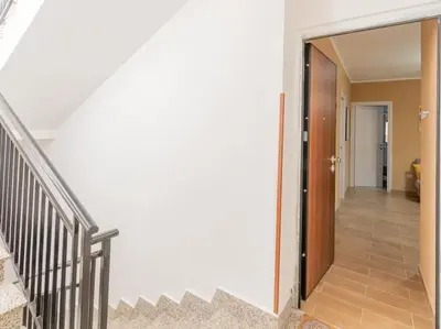 a hallway of a house with stairs and a door at Casa Vacanze La Dolce Vita in Mandra Capreria