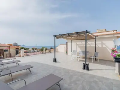 a patio with benches and tables on top of a building at Casa Vacanze Ginevra in Mandra Capreria