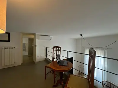 a room with a table with a laptop on it at Laura's Apartment in Palermo