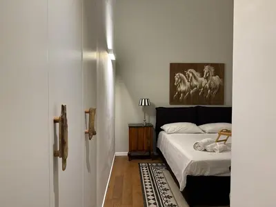 a bedroom with a bed and a painting on the wall at Laura's Apartment in Palermo
