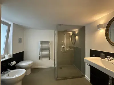 a bathroom with a shower and a toilet and a sink at Laura's Apartment in Palermo