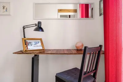 a room with a desk with a chair and a mirror at Azizò, la Gialla in Palermo